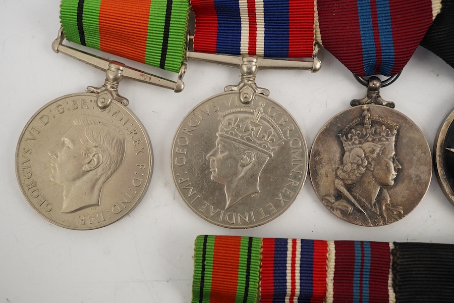 A WWII and later medal group of five medals, together with its miniature set, comprising; The Defence Medal, the 1939-1945 medal, the ERII Coronation medal, and two St. John’s Ambulance Service medals. Condition - fair t